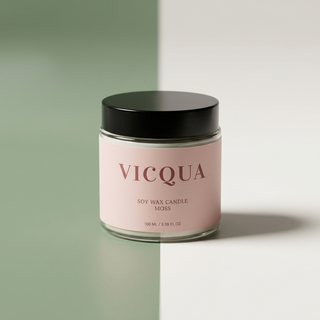 Vicqua candle with pink label and black lid on a two-tone background